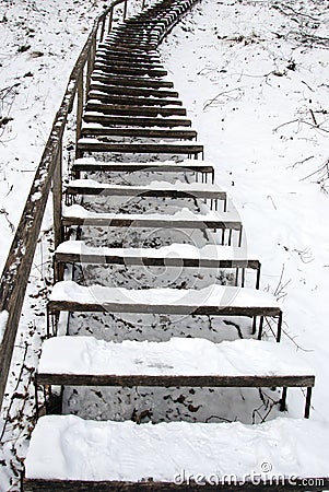 Stairs covered snow leading steep hill winter