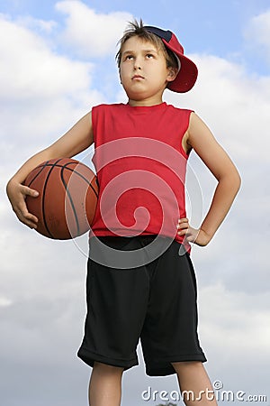 Standing child holding a basketball