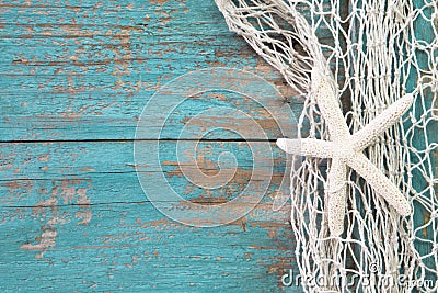 Starfish in a fishing net with a turquoise wooden background sha