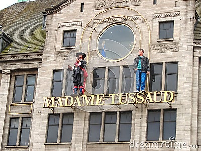 Statues on the facade of the museum Madame Tussauds in Amsterdam