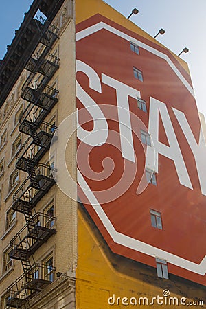 Stay sign painted on building