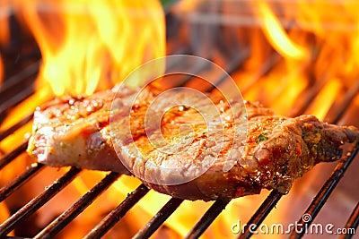 Steak on grill with flames