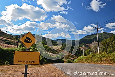 Steep road sign and rural landscape