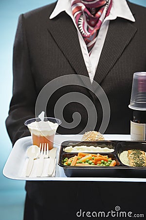 Stewardess Holding Tray With Airplane Food