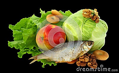 Still life of lettuce, cabbage, dried fruit, apple, drying, dried fish, nuts and dried apricotsIsolated on black background
