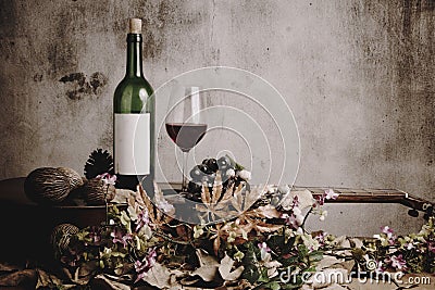 Still life of red wine bottle and wine glass