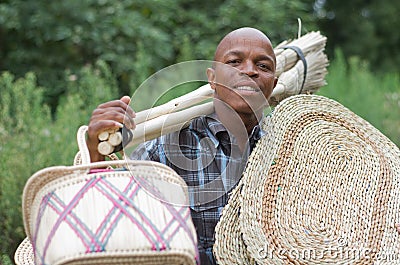 Stock photograph of South African entrepreneur small business broom salesman