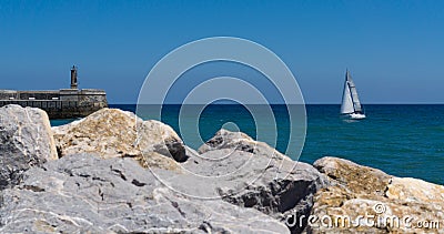 Stone Lighthouse and sailing boat