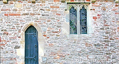 Stone wall of church with door and windows