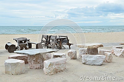 Stone and Wooden chair on beautiful beach