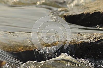 Stones in the river. Fast flowing water. Refreshing mountain river stream.