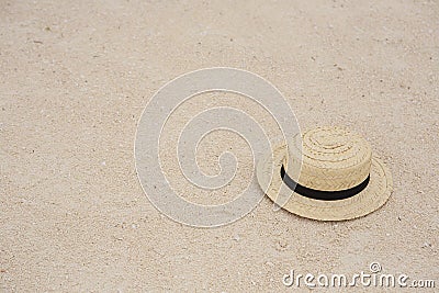 Straw sun hat in the sand