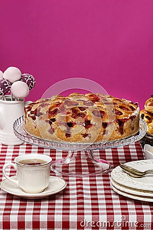 Strawberry pie on cake stand, fuchsia background