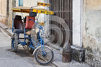 Street in Havana with an old bicycle and shabby buildings