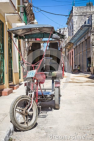Street in Havana with an old three wheeled bicycle
