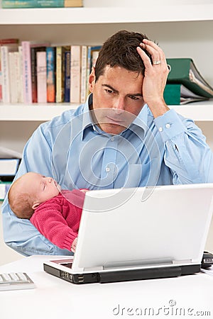 Stressed Father With Baby Working From Home