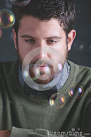 Stressed teacher man wearing stylish clothes in front a blackboard.