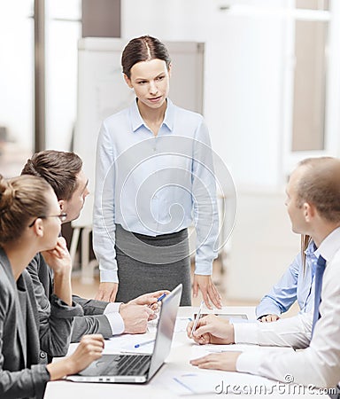 Strict female boss talking to business team