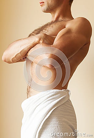 Strong young man torso with white towel