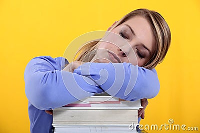 Student asleep on her books