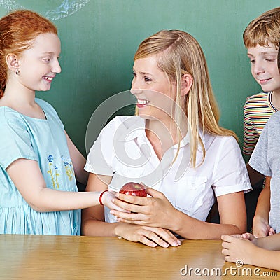 Student bringing teacher apple
