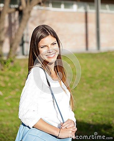 Student Carrying Shoulder Bag On College Campus