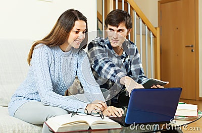 Student couple doing homework with laptop