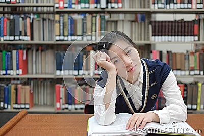 Student with open textbook deep in thought