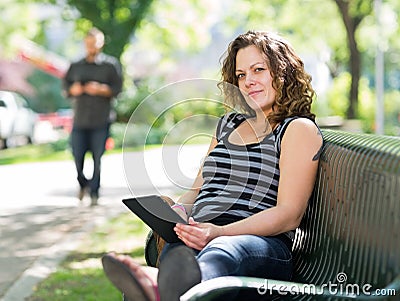 Student Relaxing On Bench At University Campus