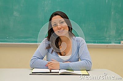 Student sitting in front of the blackboard