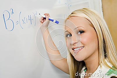 Student Solving Algebra Equation On Whiteboard