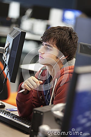 Student Using Computer And Listening Music