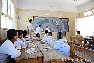 Students in classroom explaining on blackboard