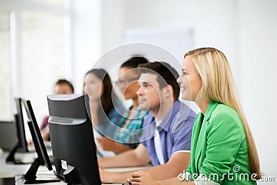 Students with computers studying at school