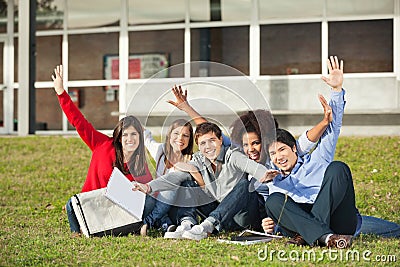 Students With Hands Raised Sitting At University