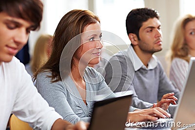 Students with laptops in class