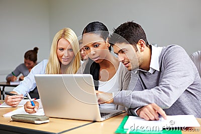 Students learning at laptop