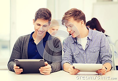Students looking at tablet pc in lecture at school