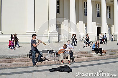 Students play pipe guitar. Street Music Day