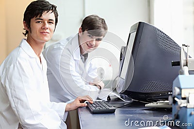 Students posing with a monitor