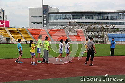 Students practise running In the sports center