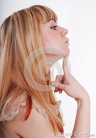 Studio portrait of young pensive woman in profile