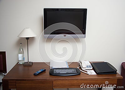 Study room with writing desk keyboard phone lamp and lcd tv set