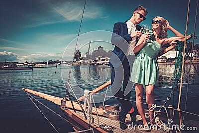 http://thumbs.dreamstime.com/x/stylish-couple-luxury-yacht-wealthy-56304567.jpg