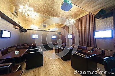 Stylish karaoke bar with leather armchairs