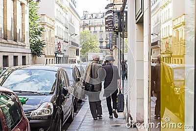 Stylish older couple strolls down Paris street