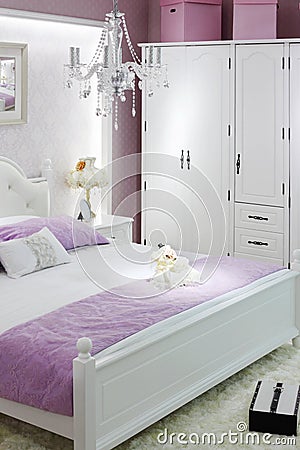 Stylish white bedroom with double bed