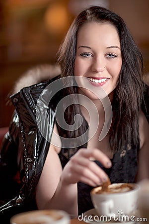 Stylish woman having coffee in a restaurant