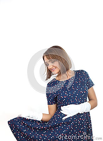 Stylish woman wearing polka dots dress and feeling good and dancing in the studio