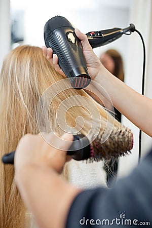 Stylist Drying Woman s Hair In Hairdresser Salon